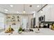 Modern kitchen with stainless appliances, white cabinets, pendant lights, and colorful backsplash at 2452 Bayshore Blvd, Dunedin, FL 34698
