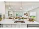 Open concept kitchen featuring a large island with bar seating and an eat-in dining area at 2452 Bayshore Blvd, Dunedin, FL 34698