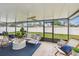 Spacious screened patio with outdoor furniture, ceiling fan, and a view of the backyard at 2452 Bayshore Blvd, Dunedin, FL 34698