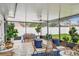 Enclosed patio with tile flooring, seating and dining area perfect for entertaining at 2452 Bayshore Blvd, Dunedin, FL 34698