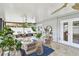 Enclosed patio with multiple seating and dining areas, ceiling fan, and views of backyard at 2452 Bayshore Blvd, Dunedin, FL 34698