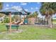 Community playground with various play structures, climbing walls, and shaded seating at 2452 Bayshore Blvd, Dunedin, FL 34698