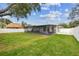Lush backyard showcasing a spacious, screened-in porch, perfect for outdoor living at 2452 Bayshore Blvd, Dunedin, FL 34698