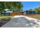 View of the backyard features a shed, wooden fence, and parking pad on a sunny day at 2819 N Central Ave, Tampa, FL 33602