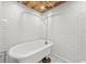 Basement bathroom features rustic wood ceiling, subway tile and classic clawfoot tub at 2819 N Central Ave, Tampa, FL 33602