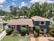 Beautiful exterior of a two-story home with manicured lawn, plants, and a new roof at 2819 N Central Ave, Tampa, FL 33602