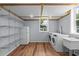 Bright laundry room has new appliances and ample shelving for storage at 2819 N Central Ave, Tampa, FL 33602