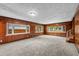 Spacious living room with wood paneling, neutral carpet, and multiple windows at 2819 N Central Ave, Tampa, FL 33602