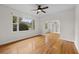 Bright living room featuring hardwood floors, a ceiling fan, and an archway to a built-in bookcase at 2819 N Central Ave, Tampa, FL 33602