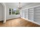 Bright living room featuring hardwood floors, chandelier, and a large built-in bookcase at 2819 N Central Ave, Tampa, FL 33602
