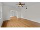 Bright living room featuring hardwood floors, a ceiling fan, and an archway to a built-in bookcase at 2819 N Central Ave, Tampa, FL 33602