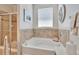 Bright bathroom featuring a soaking tub and glass shower at 2823 Holly Bluff Ct, Plant City, FL 33566