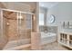 Bright bathroom featuring a separate soaking tub and tiled shower at 2823 Holly Bluff Ct, Plant City, FL 33566