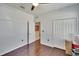 Bright bedroom showcases a ceiling fan, hardwood floors, and closet space at 2823 Holly Bluff Ct, Plant City, FL 33566