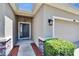 Home entryway featuring a stylish light fixture, and a combination stone and stucco facade at 2823 Holly Bluff Ct, Plant City, FL 33566