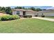Well-maintained single-story home with a large lawn and mature landscaping at 2823 Holly Bluff Ct, Plant City, FL 33566