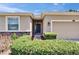 Close-up of a home's entrance, highlighting the front door, landscaping, and exterior details at 2823 Holly Bluff Ct, Plant City, FL 33566