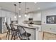 Bright kitchen with white cabinets, stainless steel appliances and bar seating at 2823 Holly Bluff Ct, Plant City, FL 33566