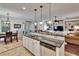Modern kitchen island features a breakfast bar and seamlessly connects to the dining and living areas at 2823 Holly Bluff Ct, Plant City, FL 33566