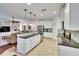 Kitchen with breakfast bar, stainless steel appliances and an open design that flows into the living area at 2823 Holly Bluff Ct, Plant City, FL 33566
