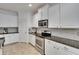 Well-equipped kitchen featuring sleek stainless steel appliances, granite counters and white cabinetry at 2823 Holly Bluff Ct, Plant City, FL 33566