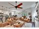 Bright living room with open layout showcases stylish furniture, ceiling fan and adjacent breakfast nook at 2823 Holly Bluff Ct, Plant City, FL 33566