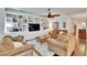 Comfortable living room with built-in bookshelves, ceiling fan, and plush sofas at 2823 Holly Bluff Ct, Plant City, FL 33566