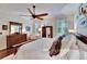 Bright main bedroom with large bed, ceiling fan, and multiple windows at 2823 Holly Bluff Ct, Plant City, FL 33566