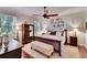 Comfortable main bedroom with a ceiling fan, plush bed, and stylish furniture at 2823 Holly Bluff Ct, Plant City, FL 33566