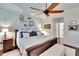Bright main bedroom featuring a ceiling fan, plush bed, and decorative shelving at 2823 Holly Bluff Ct, Plant City, FL 33566