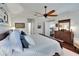Spacious main bedroom with stylish decor, plush bedding, and wood flooring at 2823 Holly Bluff Ct, Plant City, FL 33566