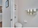 Powder room featuring a toilet, towel rack, and wall decor, showcasing a practical space at 2823 Holly Bluff Ct, Plant City, FL 33566