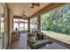 Comfortable screened porch with ceiling fans and relaxing green patio furniture at 2823 Holly Bluff Ct, Plant City, FL 33566