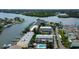 An aerial view of waterfront condos with boat docks and a community pool at 318 Windrush Blvd # 10, Indian Rocks Beach, FL 33785