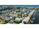 An aerial view showcasing waterfront condos, boat docks and tennis courts at 318 Windrush Blvd # 10, Indian Rocks Beach, FL 33785