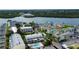 An aerial view of colorful waterfront condos with boat docks and a community pool at 318 Windrush Blvd # 10, Indian Rocks Beach, FL 33785