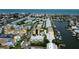An aerial view showcasing waterfront condos, boat docks and tennis courts at 318 Windrush Blvd # 10, Indian Rocks Beach, FL 33785