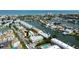 An aerial view of waterfront condos and a canal leading to the open ocean at 318 Windrush Blvd # 10, Indian Rocks Beach, FL 33785