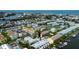 An aerial view showcasing waterfront condos, boat docks and tennis courts at 318 Windrush Blvd # 10, Indian Rocks Beach, FL 33785