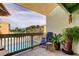Relaxing balcony with seating overlooking the community pool and tropical landscaping at 318 Windrush Blvd # 10, Indian Rocks Beach, FL 33785