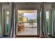 Balcony view showcasing a seating area with a view of palm trees and a building at 318 Windrush Blvd # 10, Indian Rocks Beach, FL 33785