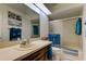 Well-lit bathroom featuring beach decor, vanity, sink, and a bathtub at 318 Windrush Blvd # 10, Indian Rocks Beach, FL 33785
