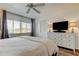 Well-lit bedroom with wood floors and a large window with blinds at 318 Windrush Blvd # 10, Indian Rocks Beach, FL 33785