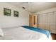 Bright bedroom with hardwood floors, a ceiling fan, and closet space at 318 Windrush Blvd # 10, Indian Rocks Beach, FL 33785
