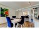 Stylish dining area that seamlessly flows into the living space, bathed in natural light and adorned with colorful artwork at 318 Windrush Blvd # 10, Indian Rocks Beach, FL 33785
