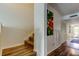 Hallway with wood floors, staircase, art and access to closets and other rooms at 318 Windrush Blvd # 10, Indian Rocks Beach, FL 33785