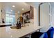 Bright open kitchen featuring quartz countertops, stylish barstool seating, stainless steel appliances, and modern finishes at 318 Windrush Blvd # 10, Indian Rocks Beach, FL 33785
