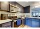 Modern kitchen with stainless appliances, dark cabinets, and light countertops offers efficient design at 318 Windrush Blvd # 10, Indian Rocks Beach, FL 33785