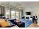 Comfortable living room with fireplace, TV, stylish furnishings, and access to a deck for relaxation at 318 Windrush Blvd # 10, Indian Rocks Beach, FL 33785