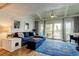 Cozy living room with high ceilings, a ceiling fan, stylish decor, and sliding glass doors to the outdoors at 318 Windrush Blvd # 10, Indian Rocks Beach, FL 33785